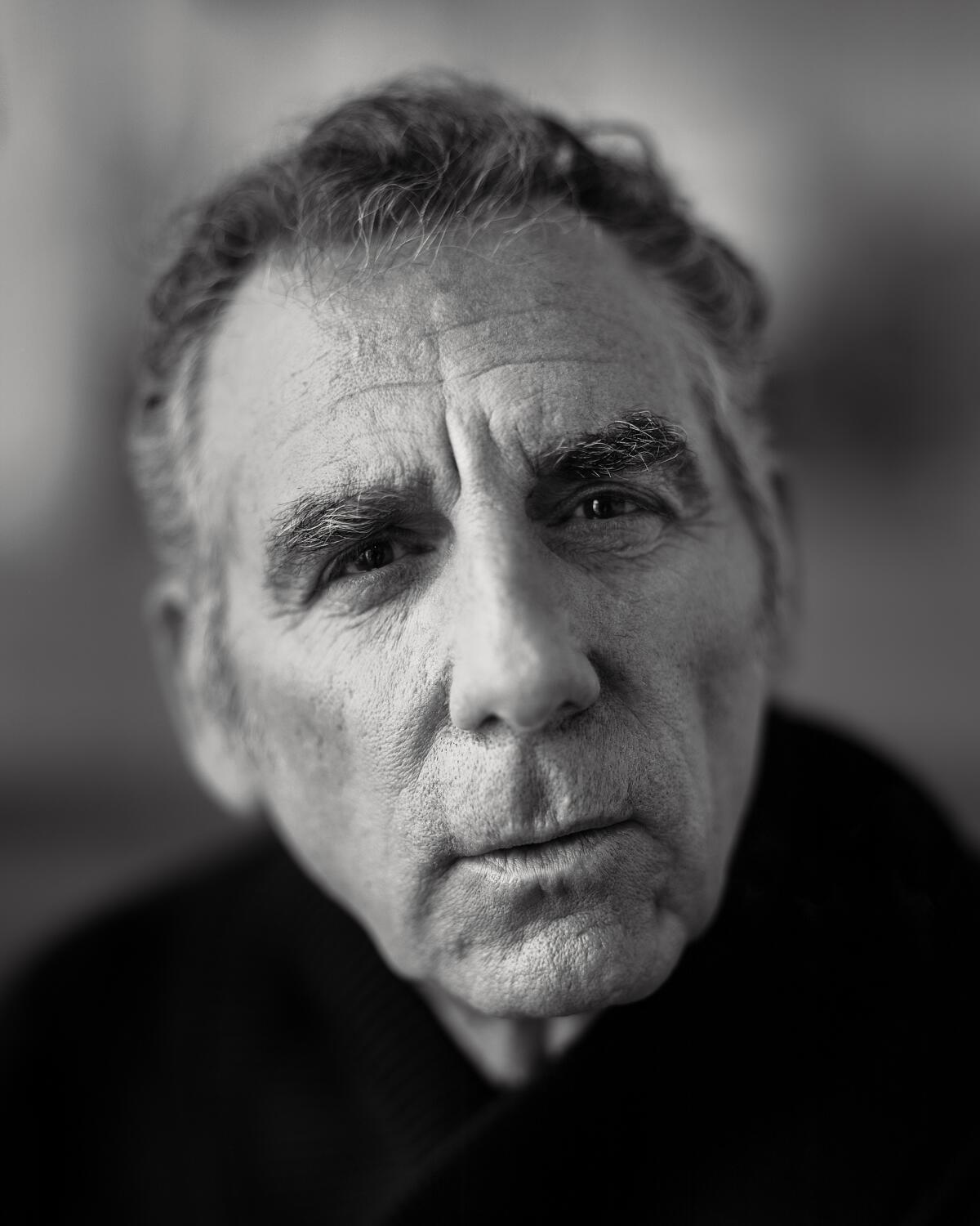 A black-and-white headshot of Michael Richards looking into the camera.