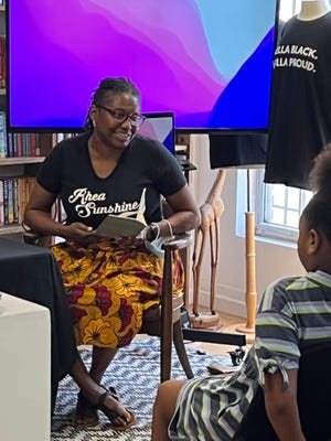 Knoxville’s former Poet Laureate Rhea Carmon reads her poem about laughter at the opening celebration for the Elandria Williams Reading and Research Room at the Bottom in Knoxville, Sept. 10, 2023.