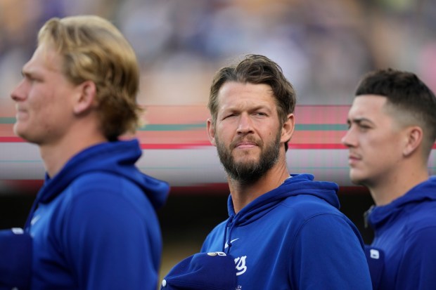 Los Angeles Dodgers' Clayton Kershaw, center, stands for the national anthem before a baseball game against the Atlanta Braves in Los Angeles, Saturday, May 4, 2024. (AP Photo/Ashley Landis)