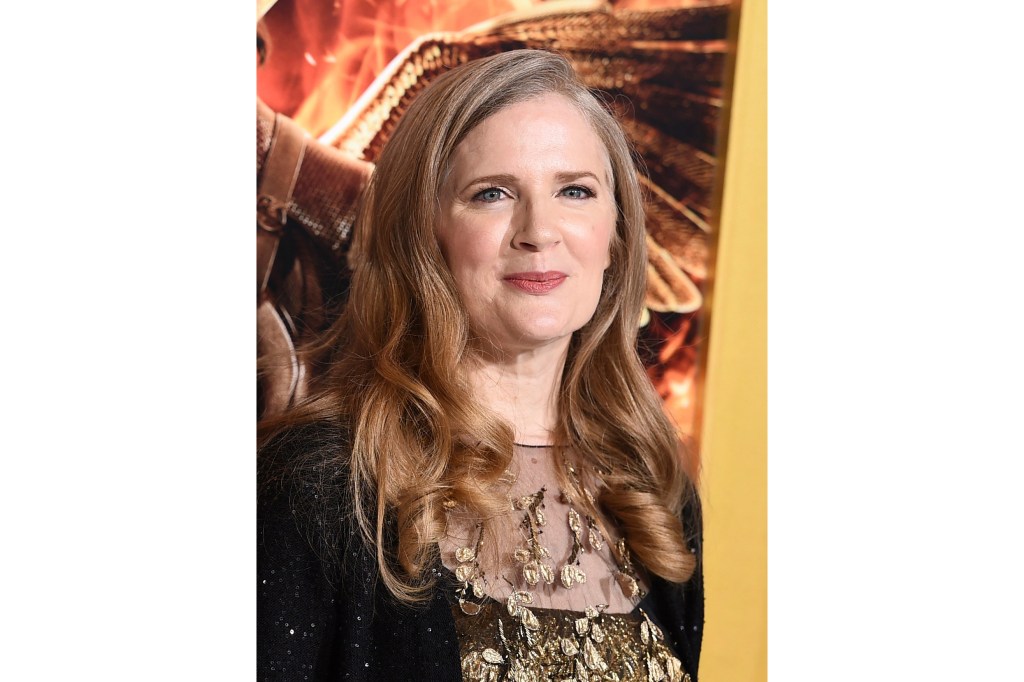 Suzanne Collins smiling at the camera upon arrival at The Hunger Games: Mockingjay - Part 1 premiere in Los Angeles, 2014