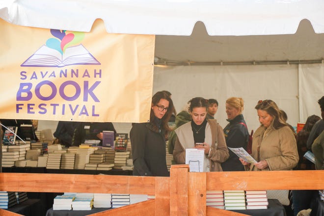 Savannah Book Festival patrons browse books available inside the bookstore tent at Telfair Square.