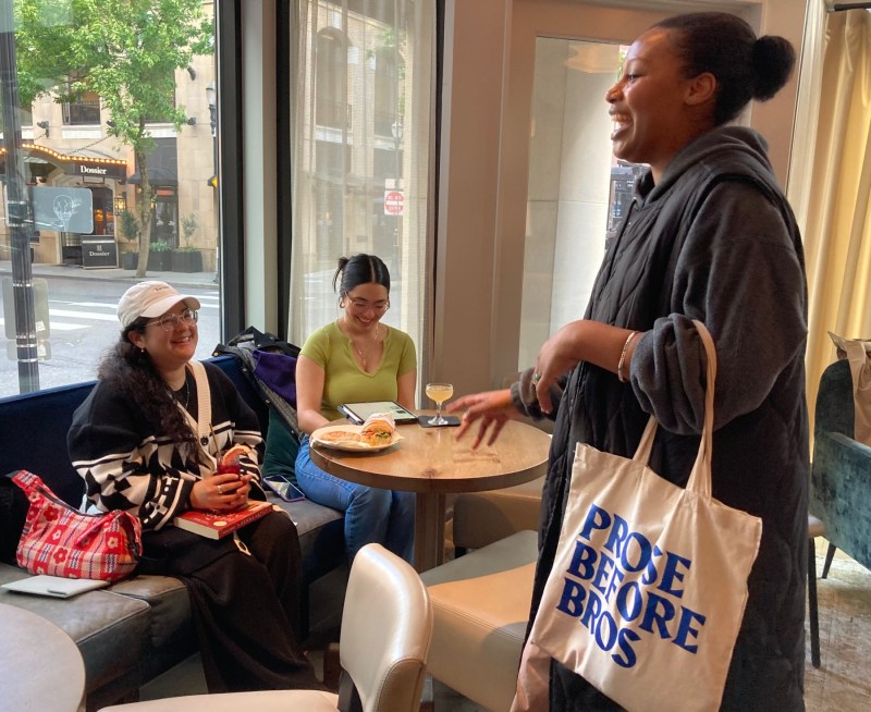 Nanea Woods (with tote) visits with two participants in Prose Before Bros' May "reading hour" at the Woodlark Hotel in Portland. Woods started the book club for women of color with seven people in 2018; today it has nearly 1,300 members. Photo by: Amy Wang
