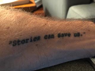 Photo of a tattoo that says "STORIES CAN SAVE US" on the arm of late narrative journalist Matt Tullis