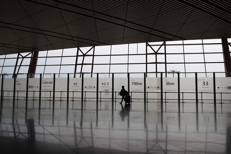 A lone passenger walks through the airport in Beijing, China.