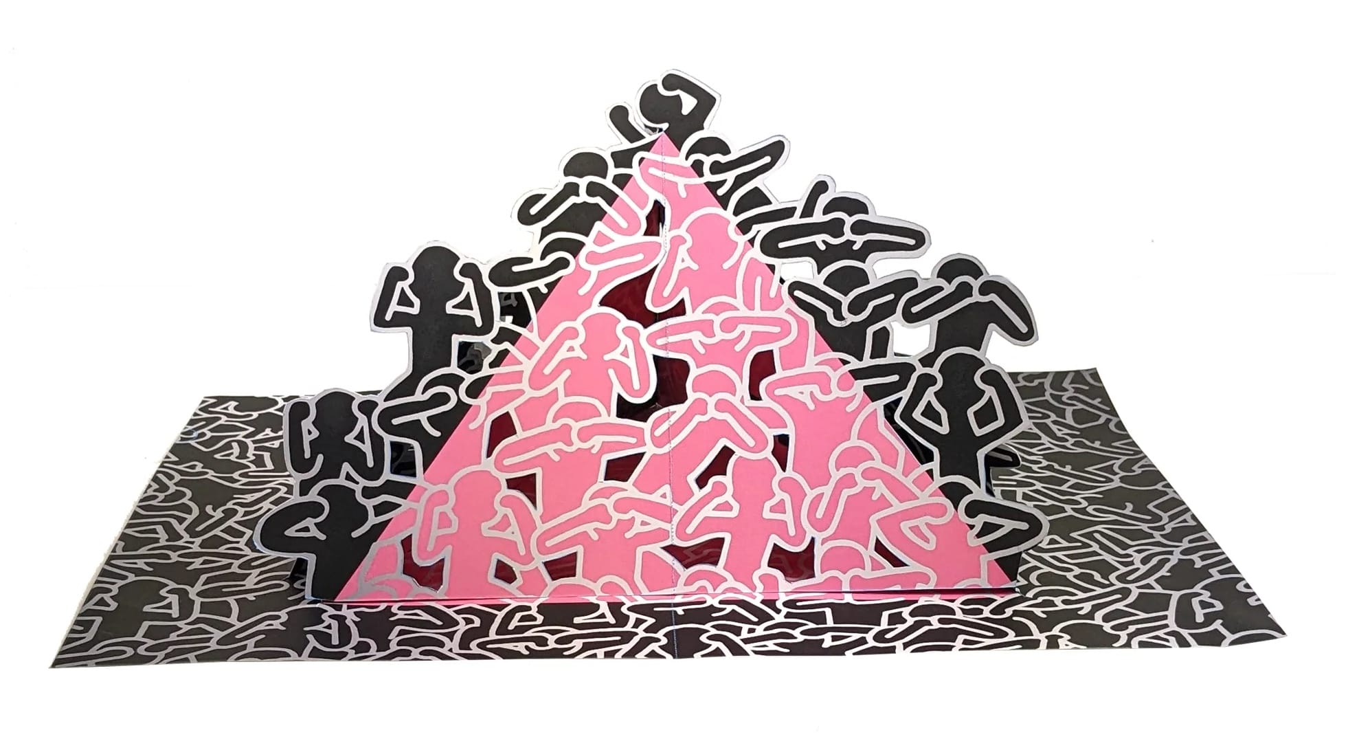 a pop-up paper spread from a pop-up book of artwork by Keith Haring, this piece depicting a pink and black pyramid made of abstract figures in a stack