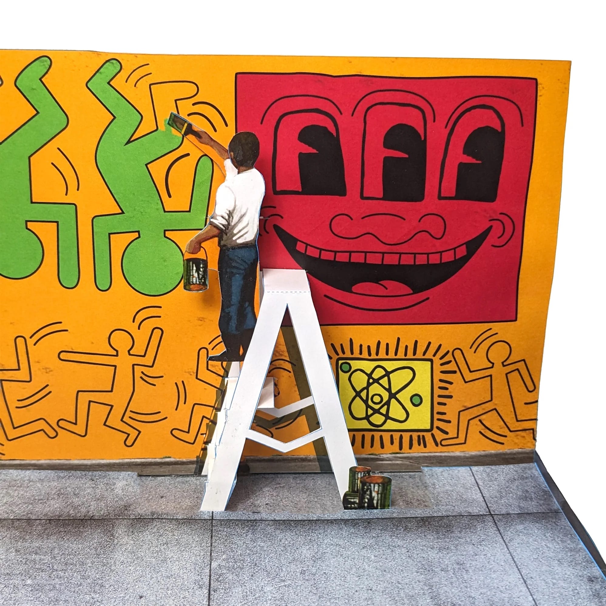 a pop-up paper spread from a pop-up book of artwork by Keith Haring, this piece depicting the artist working on a mural