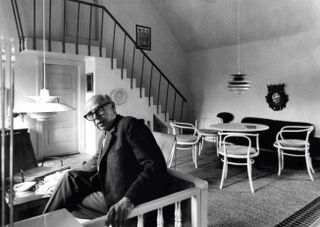 Poul Henningsen at home with a PH 5 lamp. The 1962 Contrast lamp appears in the background.